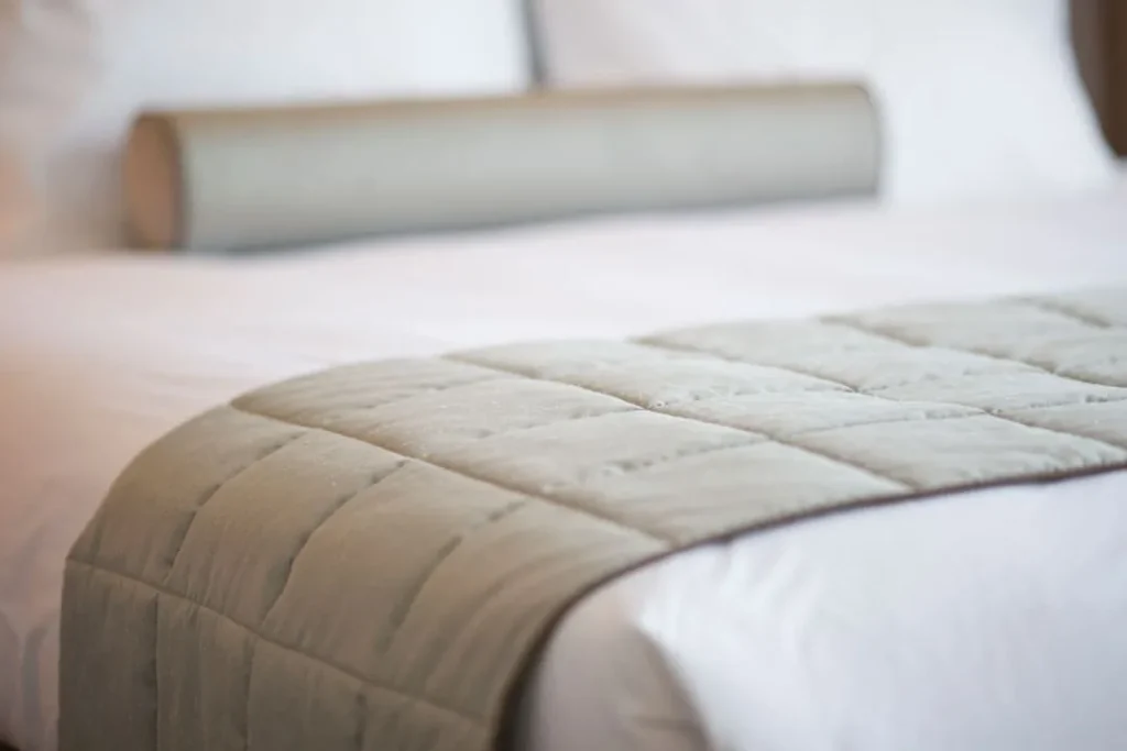 close up of a mattress with linen sheets
